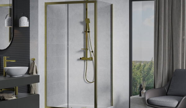 Golden Fixtures in a Concrete Bathroom